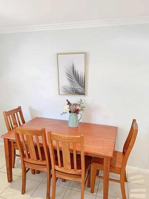 Dining table beside the open-plan living area at Brightside Apartment 1